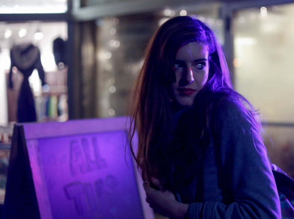 Lyndsay Jones, 22, stands in front of the Pour House Cafe on Kirkwood Ave. on Nov. 8. During her first semester at IU in 2013, she was sexually assaulted by her friend at his apartment. After completing her sophomore year at IU, she returned to Lafayette to earn enough money to return to classes at IU in the spring. She used to hang out with her friends at the Pour House and still stops by when in town to visit with friends. Lyndsay reported being sexually assaulted to the Office of Student Ethics and participated in a hearing, but her case resulted no finding.