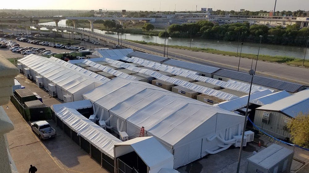 A man walks next to an immigration tent court in Laredo, Texas. With hearings expected to start this week, it still wasn&#x27;t clear if attorneys and the public would gain access to the courts, which were built by Border Patrol on the banks of the Rio Grande in South Texas.