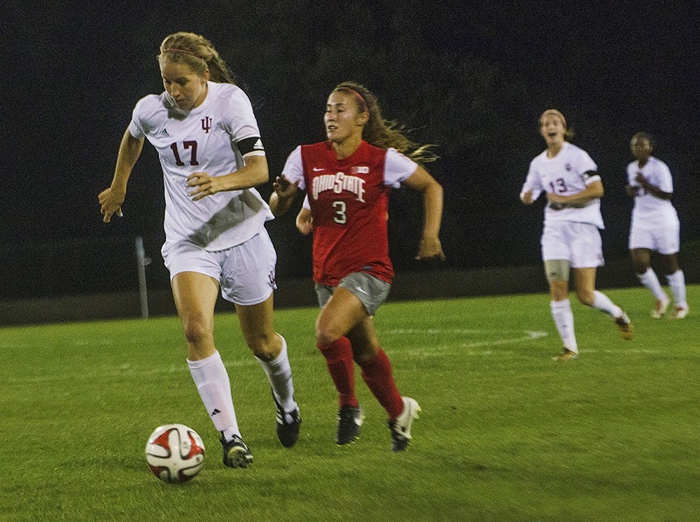 Midfielder Jordan Woolums dribbles Ohio State defender Nicole Miyashiro on September 12. Ohio State tied the game in the 90th minute and eventually won in overtime 2-1.