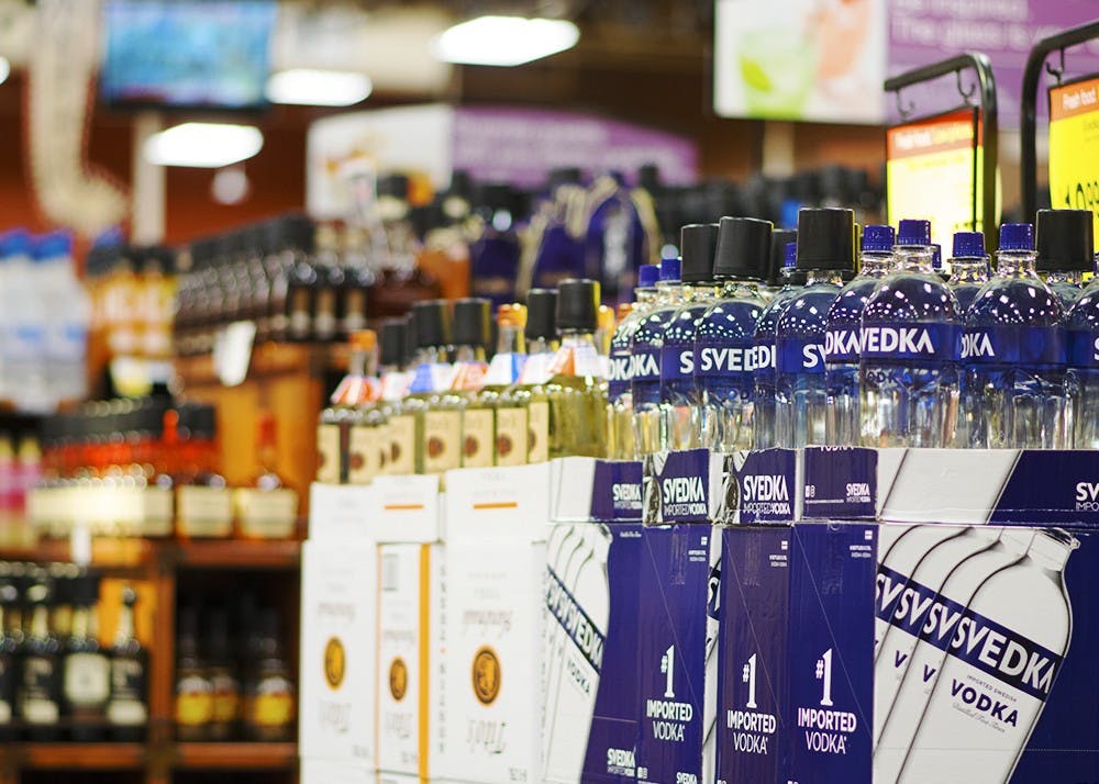 Liquor bottles line the aisles of the alcohol section of the Kroger on College Mall Road. The North-American Interfraternity Conference will ban hard liquor from chapter houses across the nation.