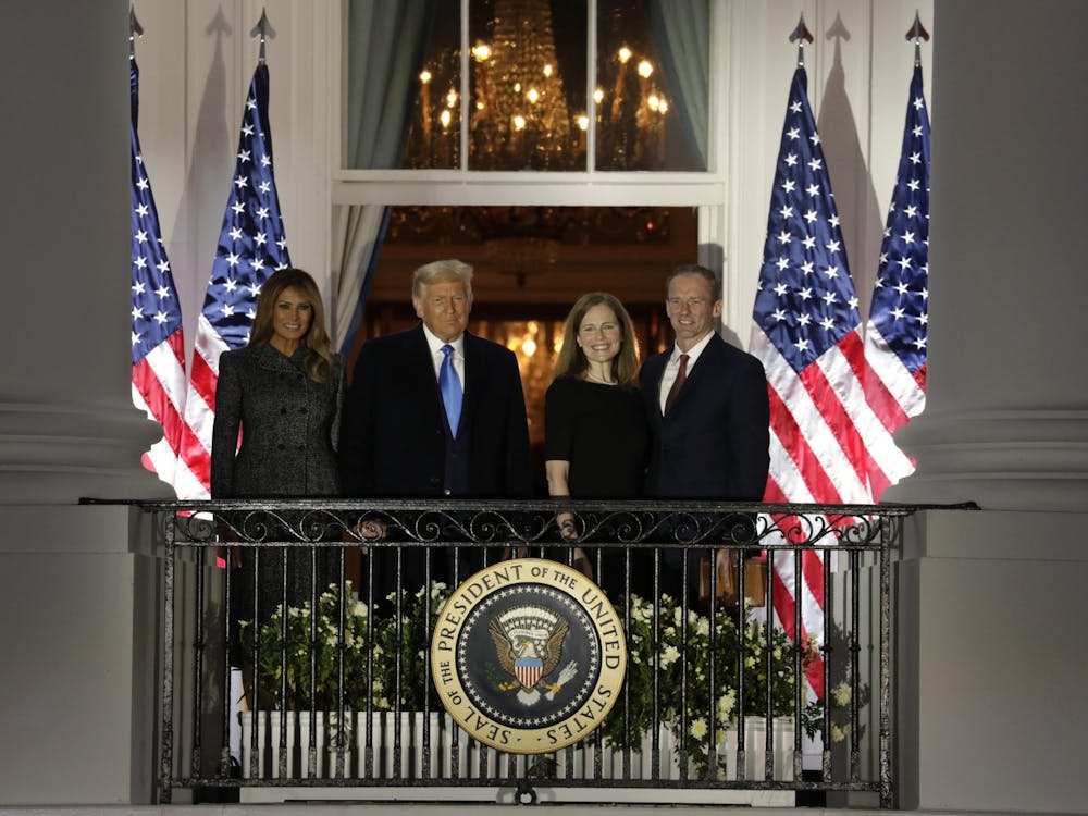 President Donald Trump with First Lady Melania Trump and new Supreme Court Associate Justice Amy Coney Barrett with her husband Jesse Barrett face guests after she was sworn in during a ceremony on the South Lawn of the White House on Oct. 26 in Washington, D.C.