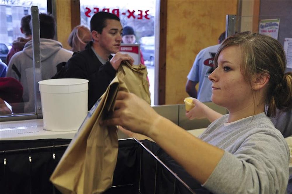 Sophomore Jessie Locke passes out bags of free breadsticks. A steady stream of customers stretching as far back as Dagwood's kept Locke busy, and most waited no longer than five minutes for their breadsticks.