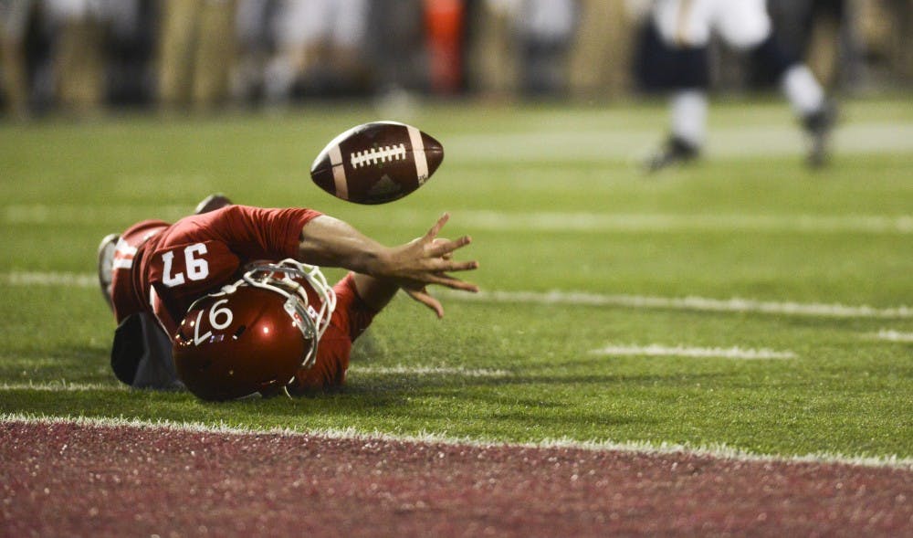 Long snapper Dan Godsil attempts to prevent the punt from going into the end zone during the against Michigan on Saturday at Memorial Stadium. The Hoosiers lost in double overtime, 41-48.