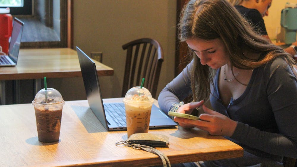 A student is photographed with their coffee Sept. 14, 2023, at the IMU Starbucks. Starbucks began serving multiple fall-themed drinks Aug. 24, including the new Pumpkin Cream Chai Tea Latte, the Apple Crisp Oatmilk Macchiato, and the classic Pumpkin Spice Latte.