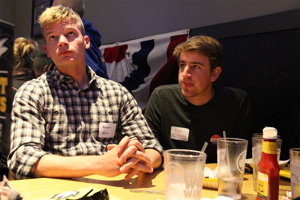 IU College Republicans Marcus Kroh, left and Kyle Osting, right, watch Ted Cruz announce the suspension of his campaign after his loss inTuesday's Indiana Primary.