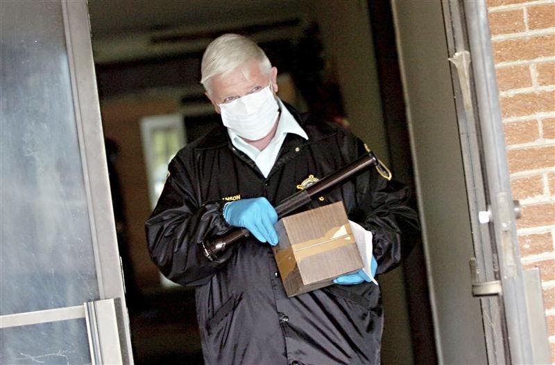 Tom Branson, Lake County coroner's chief investigator, carries a box containing cremated remains out of the former Serenity Gardens Funeral Home in Gary, Ind., Thursday May 28, 2009.  Four decomposed bodies were discovered earlier this week in the building that has been closed for several years after former funeral director Darryl Cammack lost his funeral license. 