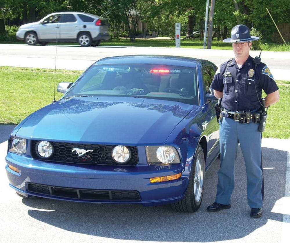 COURTESY INDIANA STATE POLICEIndiana State Trooper Troy Sunier poses with his new Mustang GT patrol car. The ISP recently received 18 Mustangs to patrol rural two-lane roads which have been a problem area for traffic fatalities.           