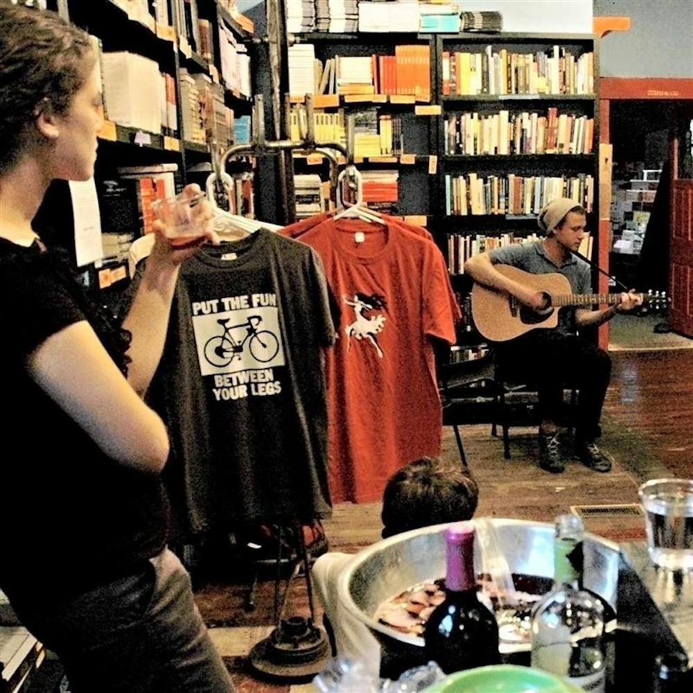 Patrons listen as IU graduate Jonah Malarsky plays music on Friday, May 22, at Boxcar Books. Malarsky’s performance was part of “An Evening of Lit and Wit,” a promotional event organized by Shanks and intended to promote local publications fiore and The Robin.