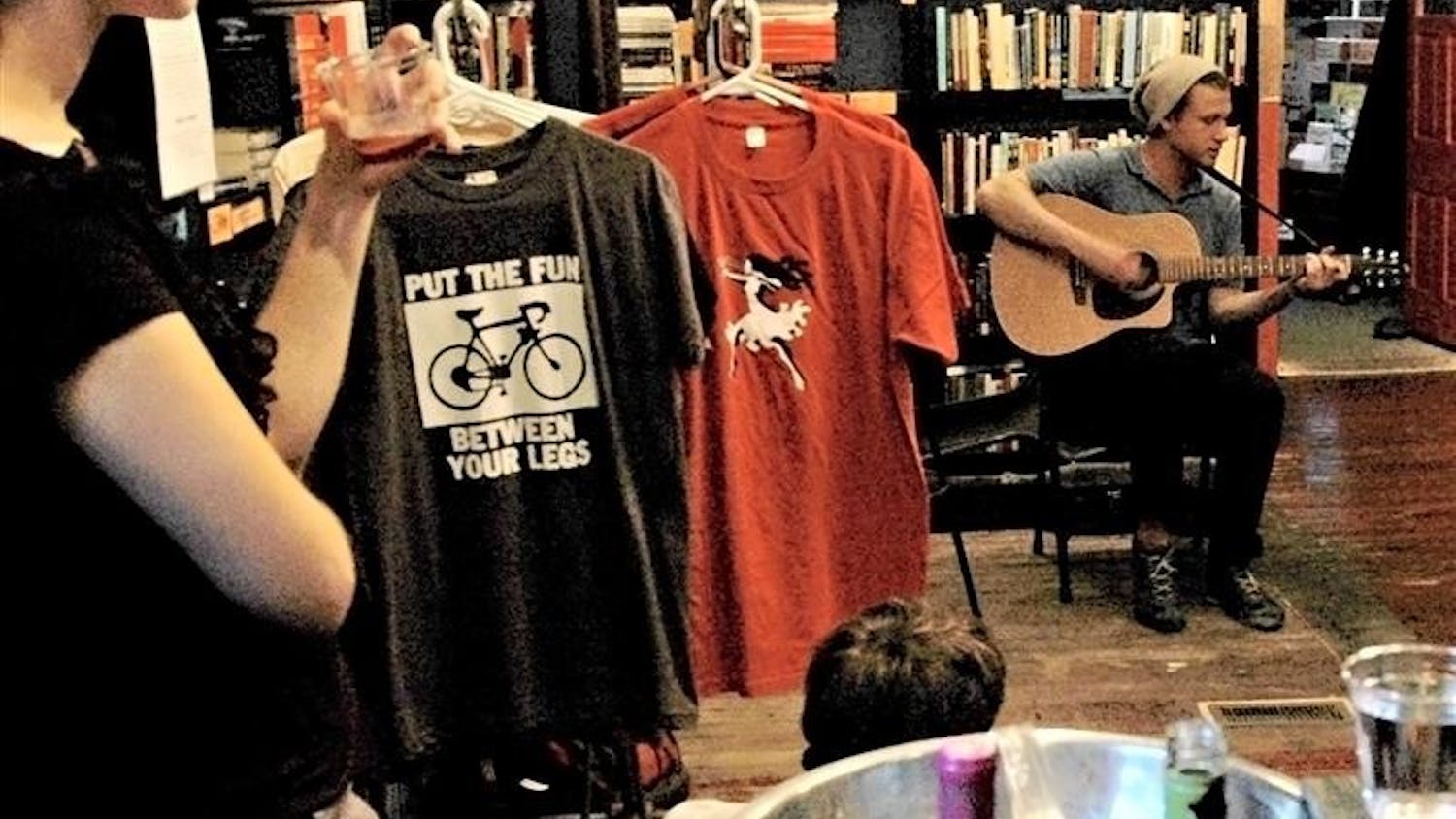 Patrons listen as IU graduate Jonah Malarsky plays music on Friday, May 22, at Boxcar Books. Malarsky’s performance was part of “An Evening of Lit and Wit,” a promotional event organized by Shanks and intended to promote local publications fiore and The Robin.