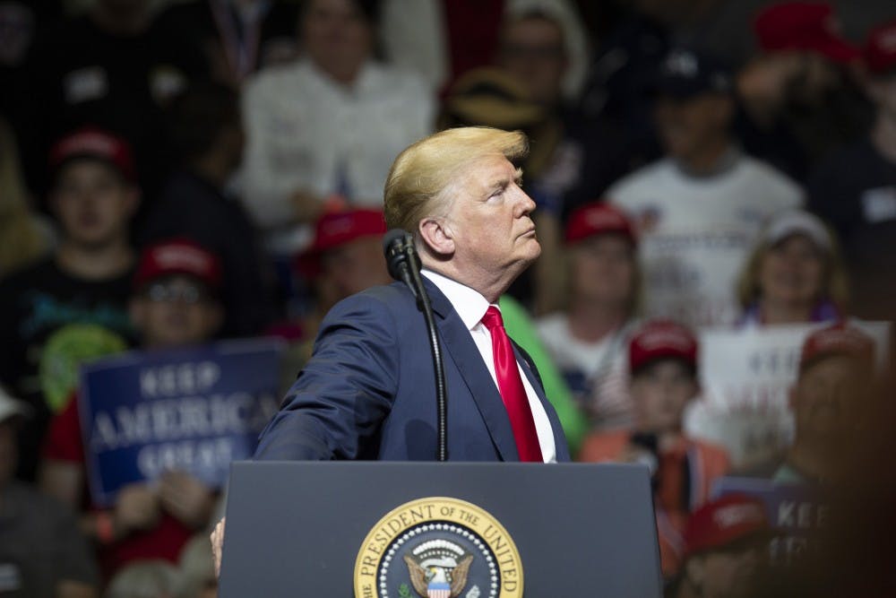 <p>President Trump pauses while the audience cheers at North Side Middle School on Thursday, May 10, in Elkhart, Indiana. Trump talked about border security, the economy and the upcoming elections in November. &nbsp;&nbsp;</p>