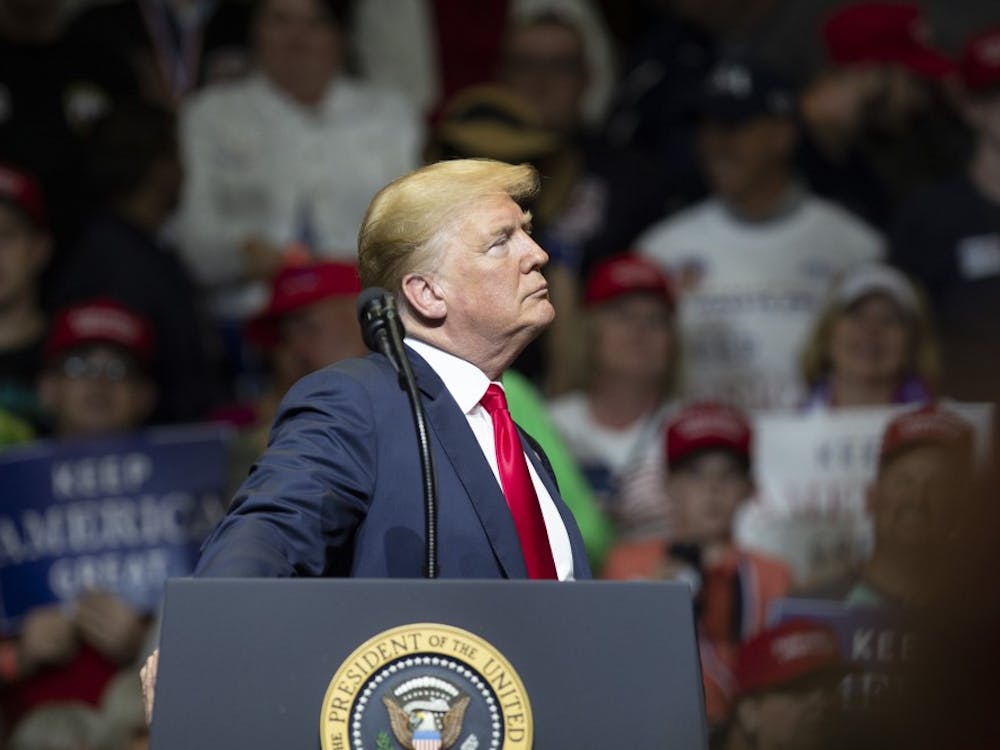President Trump pauses while the audience cheers at North Side Middle School on Thursday, May 10, in Elkhart, Indiana. Trump talked about border security, the economy and the upcoming elections in November. &nbsp;&nbsp;