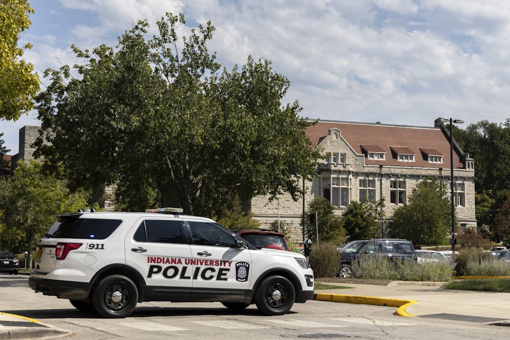 <p>An Indiana University Police Department vehicle blocks access to East Sixth Street on Tuesday across from Franklin Hall.</p>