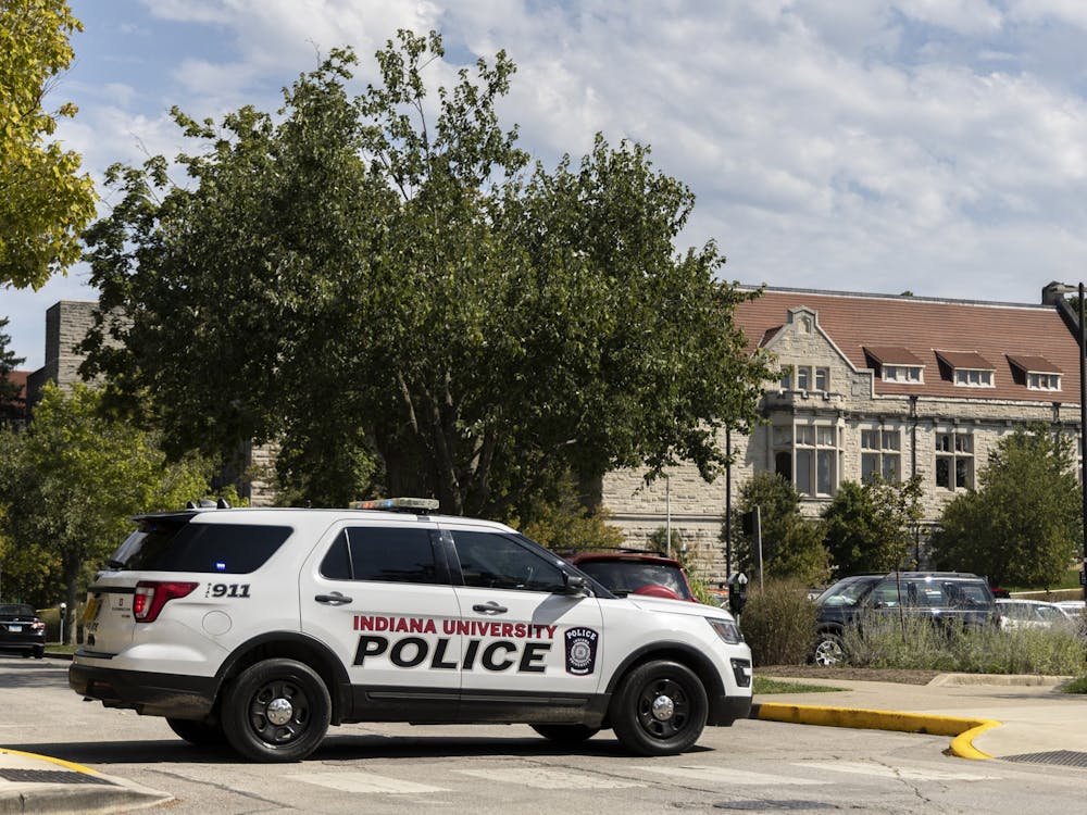 An Indiana University Police Department vehicle blocks access to East Sixth Street on Tuesday across from Franklin Hall.