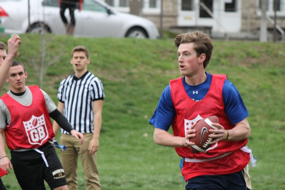 Freshman Austin Weist of Theta Chi runs with the ball during the first game of the Greek Bowl on Monday in Dunn Meadow. Greek Bowl is Sigma Nu's philanthropy event benefitting the Middle Way House. Ten different fraternities are participating in the event.