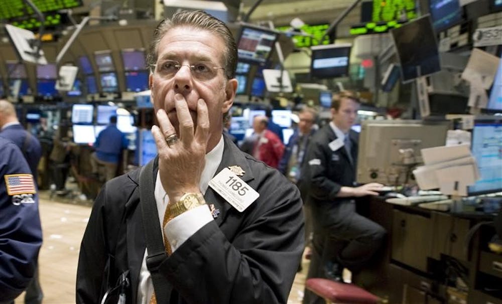 Trader Thomas Cannizzaro works Monday afternoon on the floor of the New York Stock Exchange. Fear swept across the financial markets Monday, sending the Dow Jones industrials down as much as 705 points, after the government's financial bailout package failed the House.