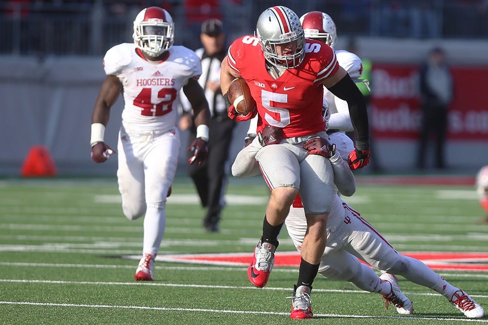 IU safety Antonio Allen tackles Ohio State tight end Jeff Heuerman. The Hoosiers lost to the Buckeyes 42-27 at Ohio Stadium on Saturday.