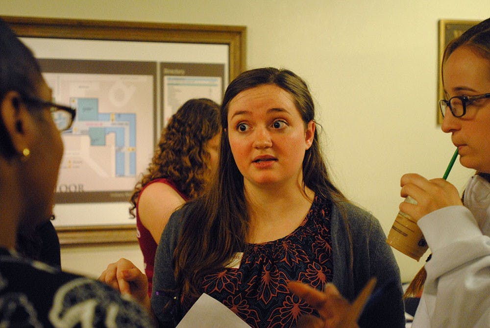 Emily discusses a plan of action with fellow organizers of OASIS's candlelight vigil. In the spring, she plans to continue her work with the office, which educates students on drug and alcohol-related problems on campus.