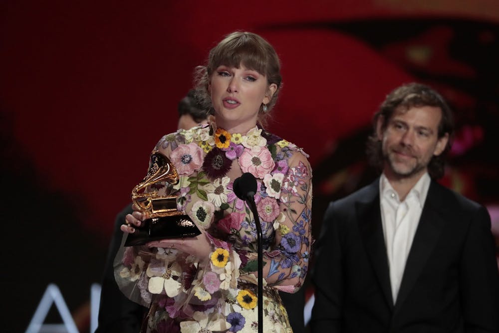 <p>Taylor Swift accepts the award for Album of the Year at the 63rd Grammy Awards on March 14 outside the Staples Center in Los Angeles. Swift has now won 11 total Grammys throughout her career.</p>