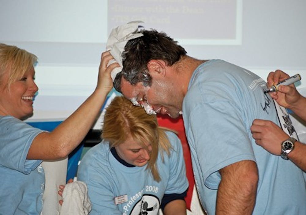 Courtesy Photo IU students Brittany Nelson and Erin Bruner help clean up Professor Kreft after he was pied. Brittany and Erin were both key contributors to the success of the Pie-A-Professor event that beat the previous IU Bowl for Kids Sake record of $5,588 by raising $12,096.13.