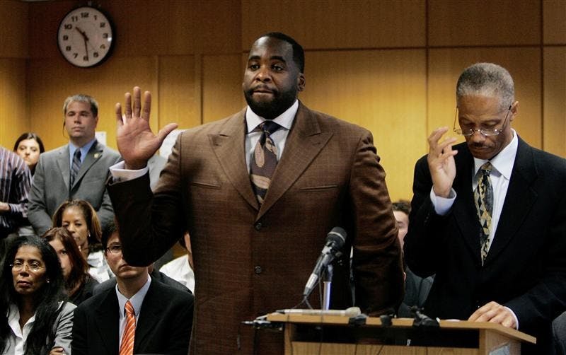 Detroit Mayor Kwame Kilpatrick stands with his attorney, Gerald Evelyn and takes his oath on Thursday in Wayne County Circuit Court in Detroit. Kilpatrick pleaded guilty to a pair of felony obstruction charges in a sex-and-misconduct scandal and will step down after months of defiantly holding onto his job leading the nation's 11th-largest city. His wife, Carlita, looks on, in the third row left.