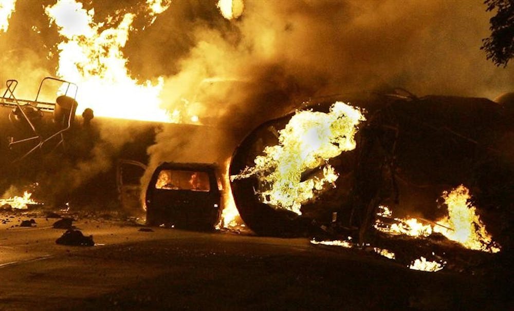 A vehicle burns near a train derailment Friday, June 19, 2009, on Mulford Road just north of Sandy Hollow Road in Rockford.