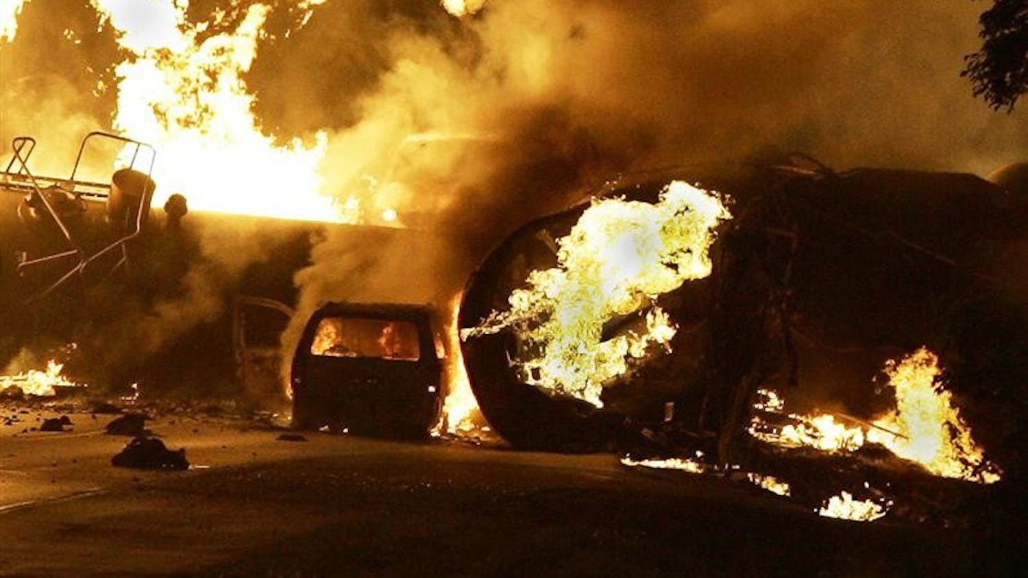 A vehicle burns near a train derailment Friday, June 19, 2009, on Mulford Road just north of Sandy Hollow Road in Rockford.