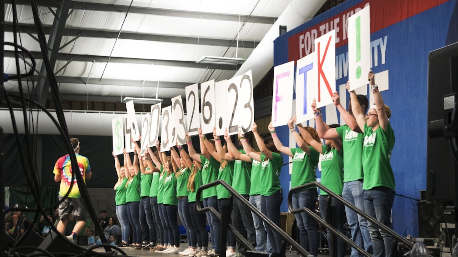 IUDM participants reveal signs displaying the total amount fundraised. The 2017 IUDM raised $4,203,326.23 for the kids.