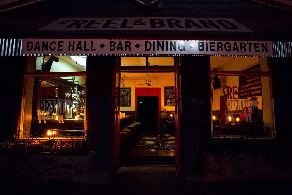 <p>Patrons sit at candle-lit tables Oct. 9 at Reel and Brand in Sonoma, California. People ate their dinner during a planned power outage by the Pacific Gas &amp; Electric utility company. </p>