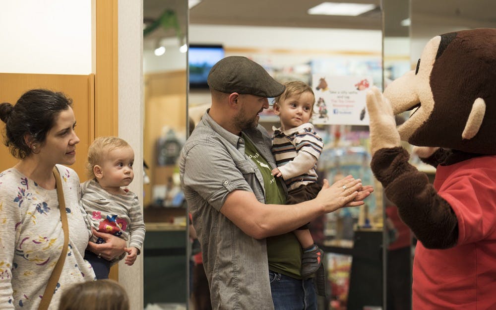 <p>David and Michelle Kloster hold their daughter and son Feb. 26, 2017, at the College Mall. Kirsten Kloepfer, an associate professor of pediatrics at IU, was the principal investigator in a study done in children ages one to three years old with confirmed peanut allergies to see if using a skin patch would desensitize them to peanuts. </p>