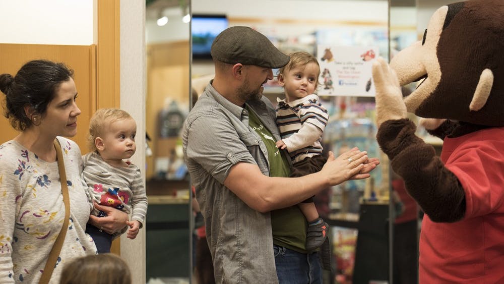 David and Michelle Kloster hold their daughter and son Feb. 26, 2017, at the College Mall. Kirsten Kloepfer, an associate professor of pediatrics at IU, was the principal investigator in a study done in children ages one to three years old with confirmed peanut allergies to see if using a skin patch would desensitize them to peanuts. 