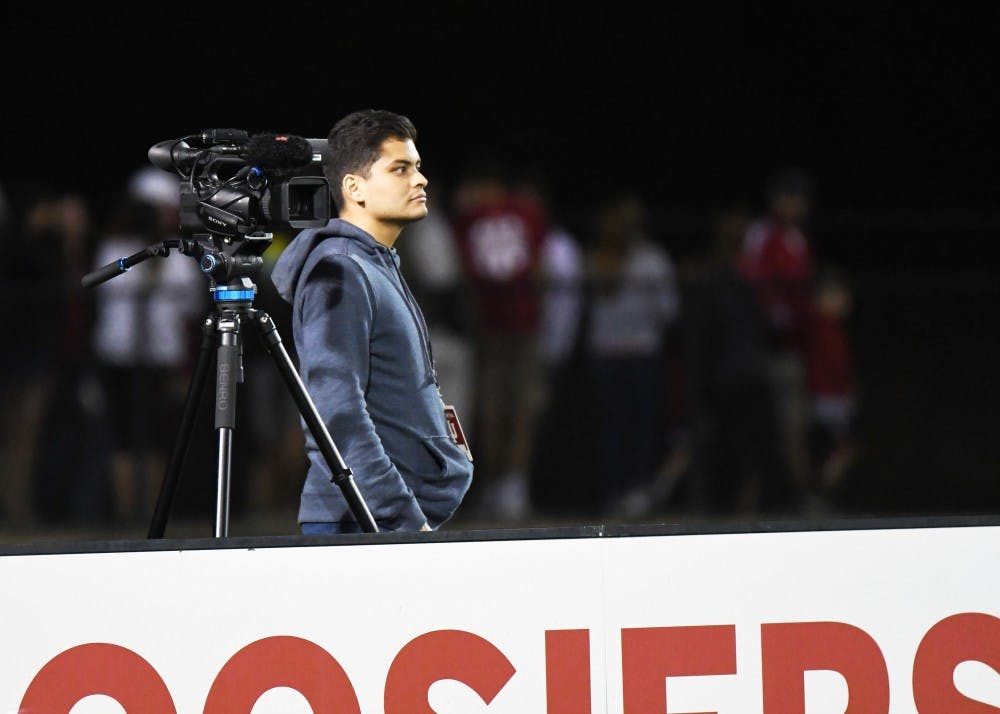 Juan Alvarado runs a video camera during the IU men's soccer game Saturday night. Alvarado did play-by-play for the Spanish-language broadcast during the IU vs. Notre Dame game on Sept. 26 and will do the same for future games against Kentucky, Butler and Wisconsin.