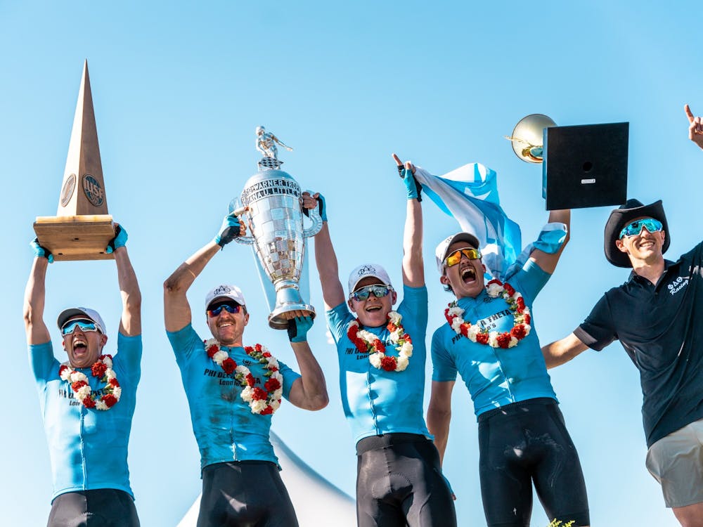 The Phi Delta Theta team hoists the winning trophies in the air after winning the Men&#x27;s Little 500 on April 23, 2022 at Bill Armstrong Stadium. The team was presented with three trophies. 