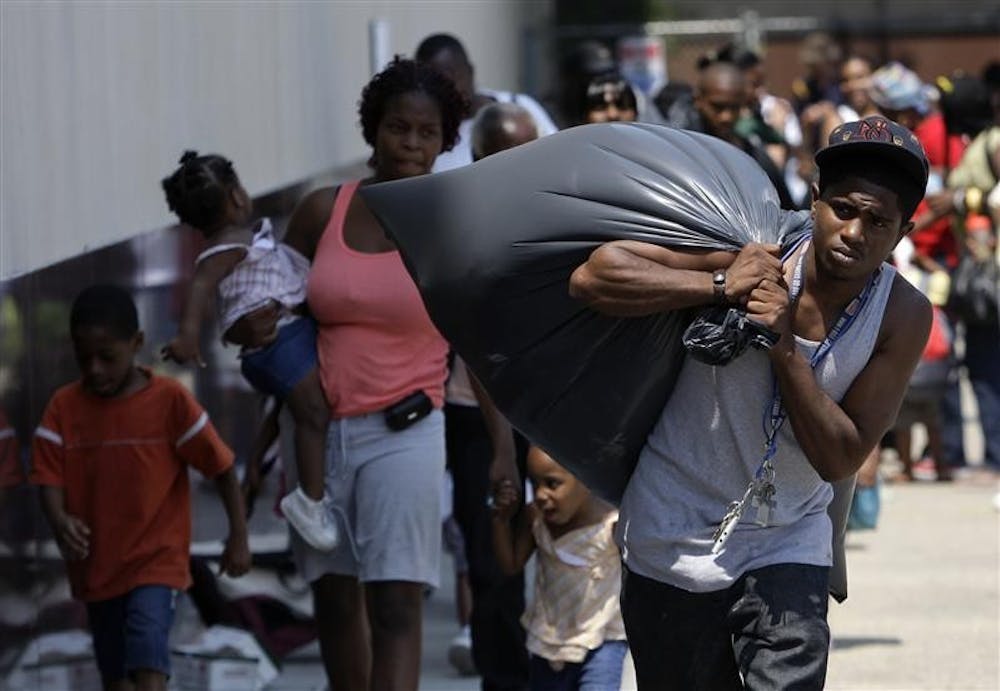 Jeffrey Vannor carries his belongings Saturday while evacuating from the approaching Hurricane Gustav at the Greyhound Bus and Amtrak station in New Orleans. A million people took to Gulf Coast highways Saturday, boarding up homes and businesses and fleeing dangerous Hurricane Gustav by bus and automobile as the season's most powerful Atlantic storm took aim at Louisiana.
