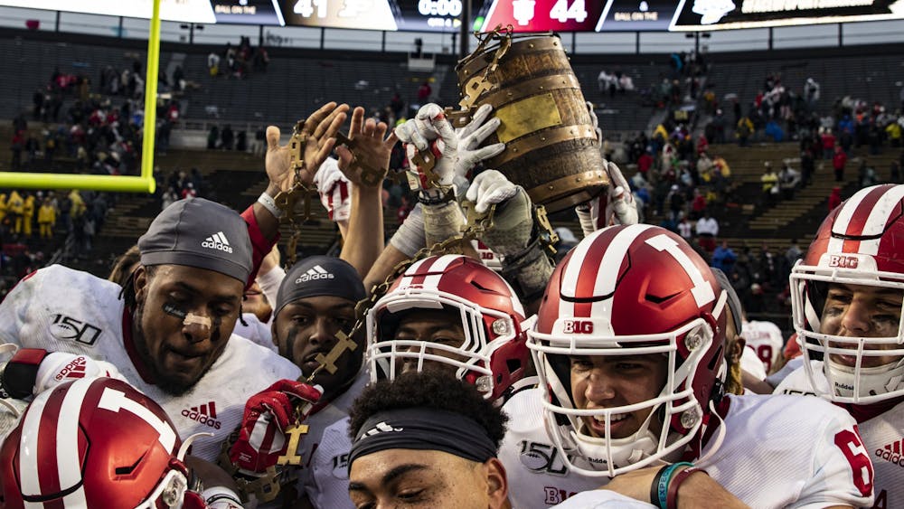 Indiana football players hold up the Oaken Bucket on Nov. 30, 2019, in Ross-Ade Stadium in West Lafayette, Indiana. 