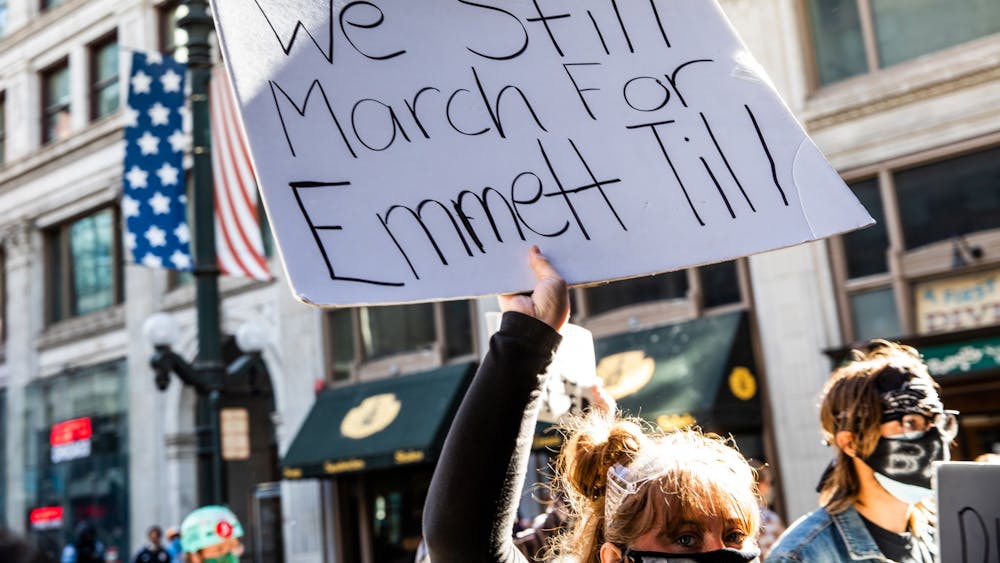 A woman holds a sign in honor of Emmett Till during a protest June 13, 2020 in Chicago.