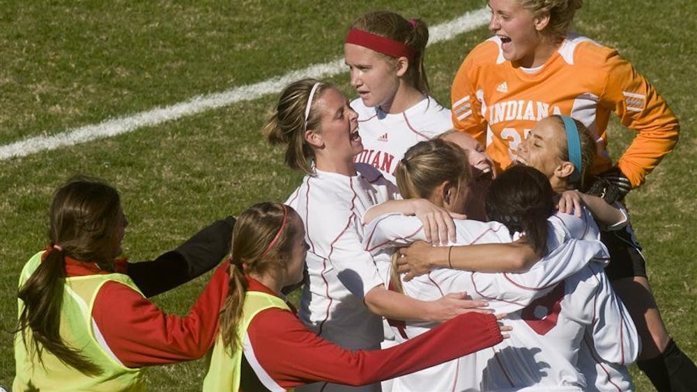 IU goalkeeper Shannon Flower (right) jumps on top of teammates as they celebrate their 1-0 win against No. 18 Ohio State on Sunday at Bill Armstrong Stadium.