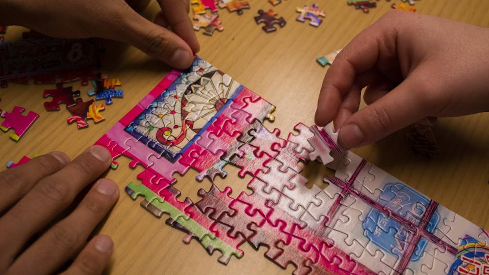 Students put together part of a puzzle Jan. 29 inside Franklin Hall. The fifth annual Monroe County History Center PuzzleFest will take place at 10 a.m. Feb. 1 in the Girls Inc. of Monroe County gymnasium.