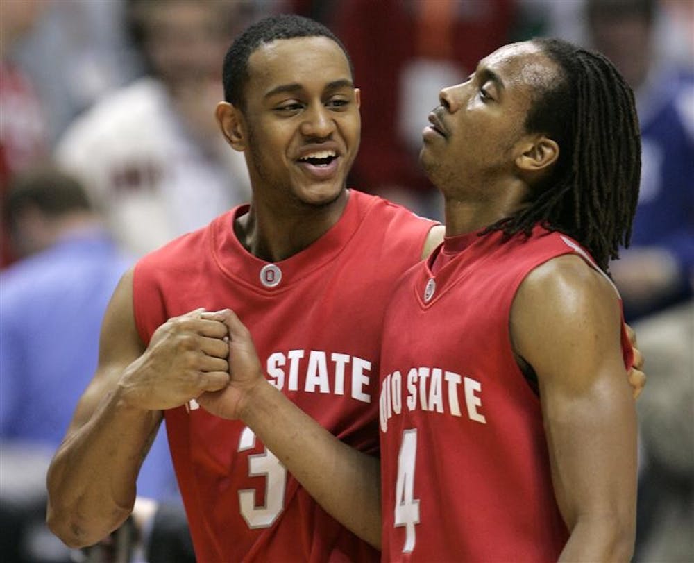 Ohio State guard Walter Offutt (3) and guard P.J. Hill grip each other's hand as they walk off the court after Ohio State beat Michigan State 82-70 in an NCAA college basketball game during the semifinals of the Big Ten men's tournament Saturday in Indianapolis.