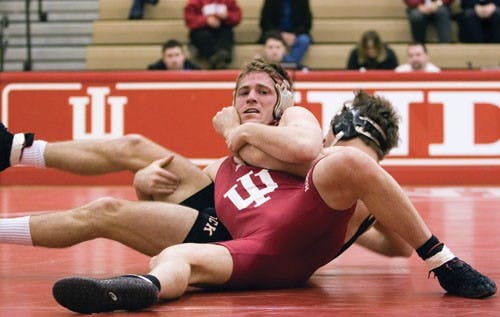 IDS File PhotoA member of the IU wrestling team grapples with an opponent during a meet with North Carolina State Feb. 3 in the University Gym.  