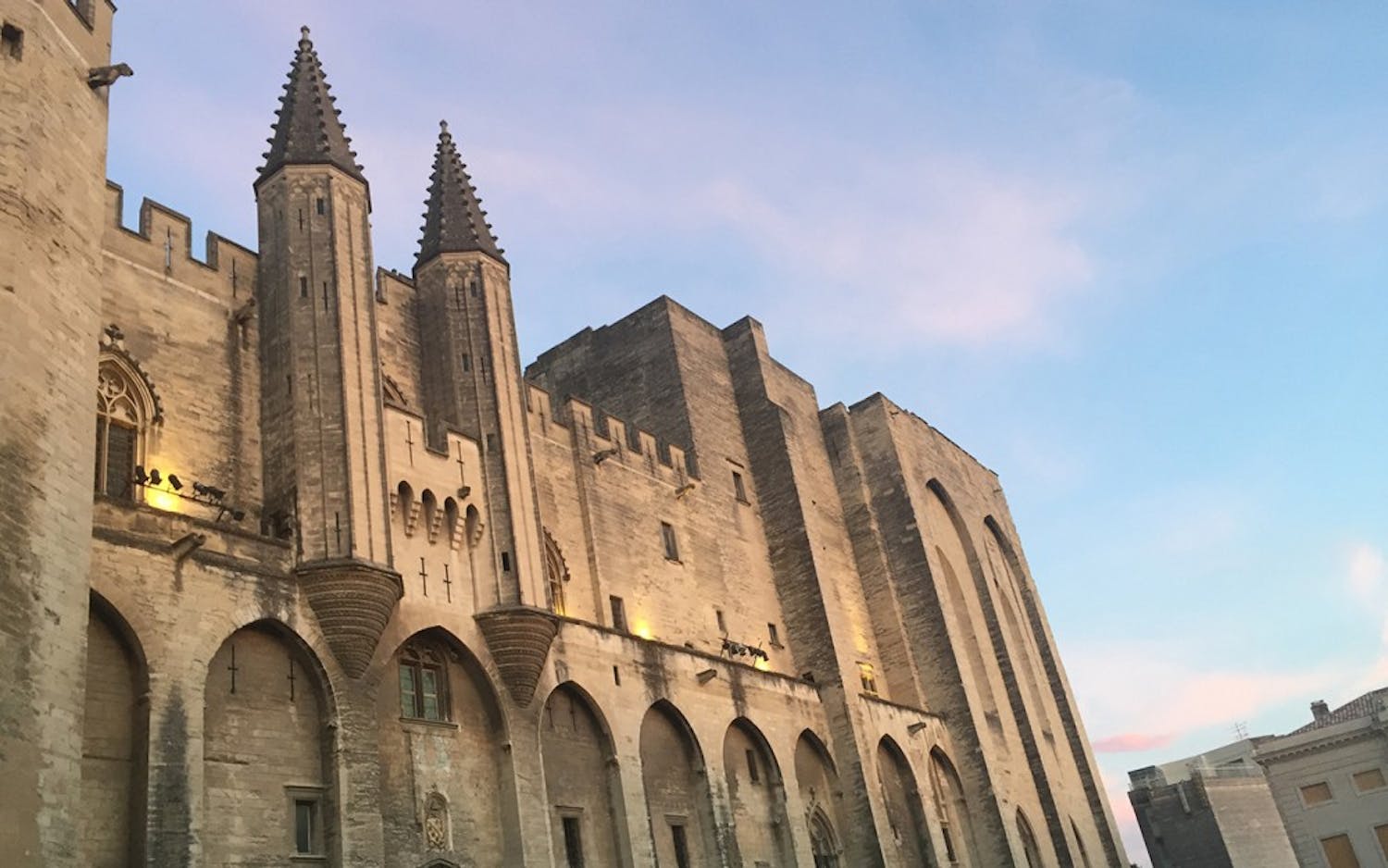 The sun sets at the Palais des Papes in the ancient city center of Avignon. Avignon is known historically as the medieval capital of the Christian church, but still stands almost 700 years later.