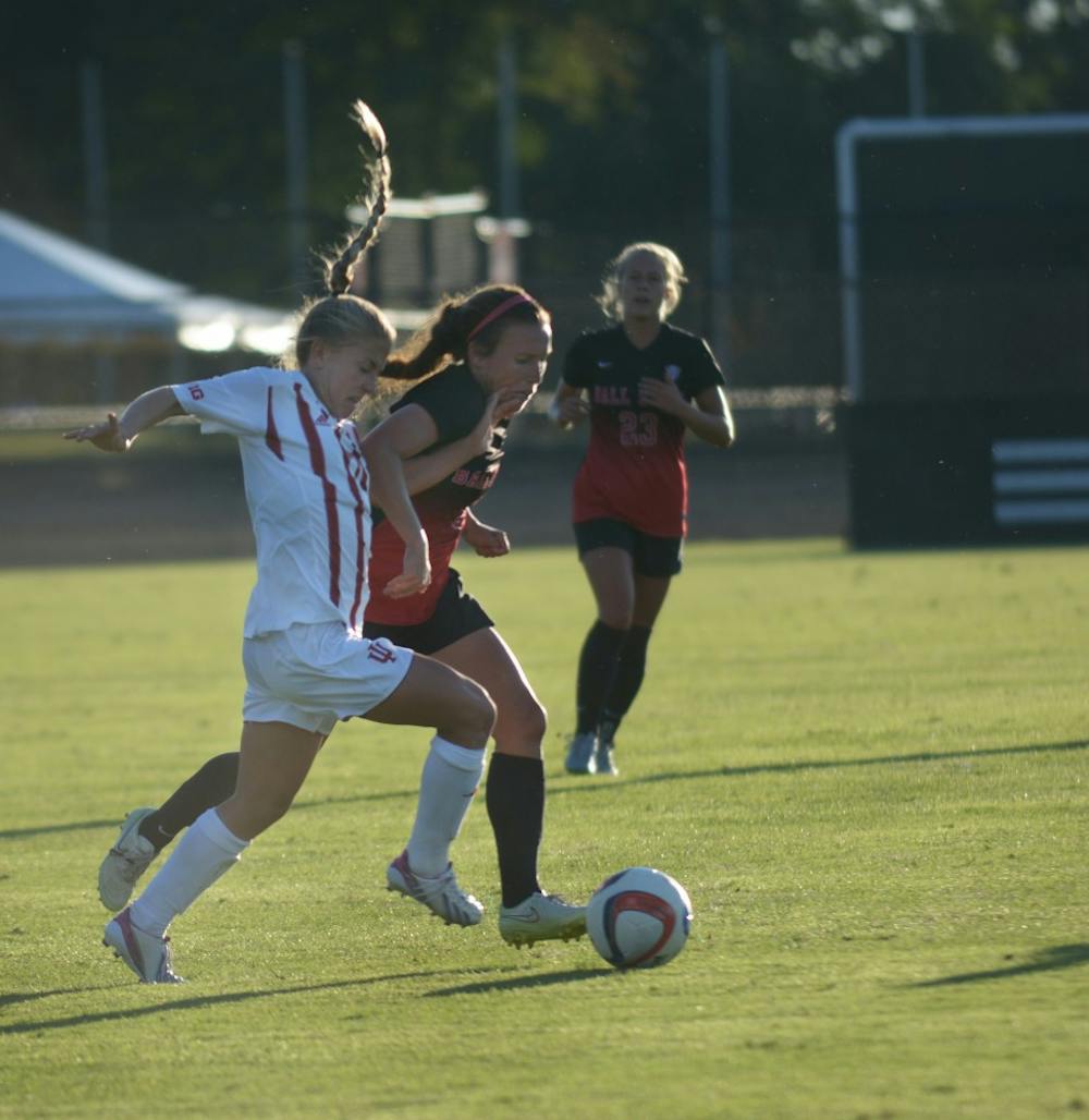 Sophomore Midfielder Kayla Smith holds off a Ball State University Cardinals' defender at Bill Armstrong stadium on Sunday evening. IU tied the game 1-1.