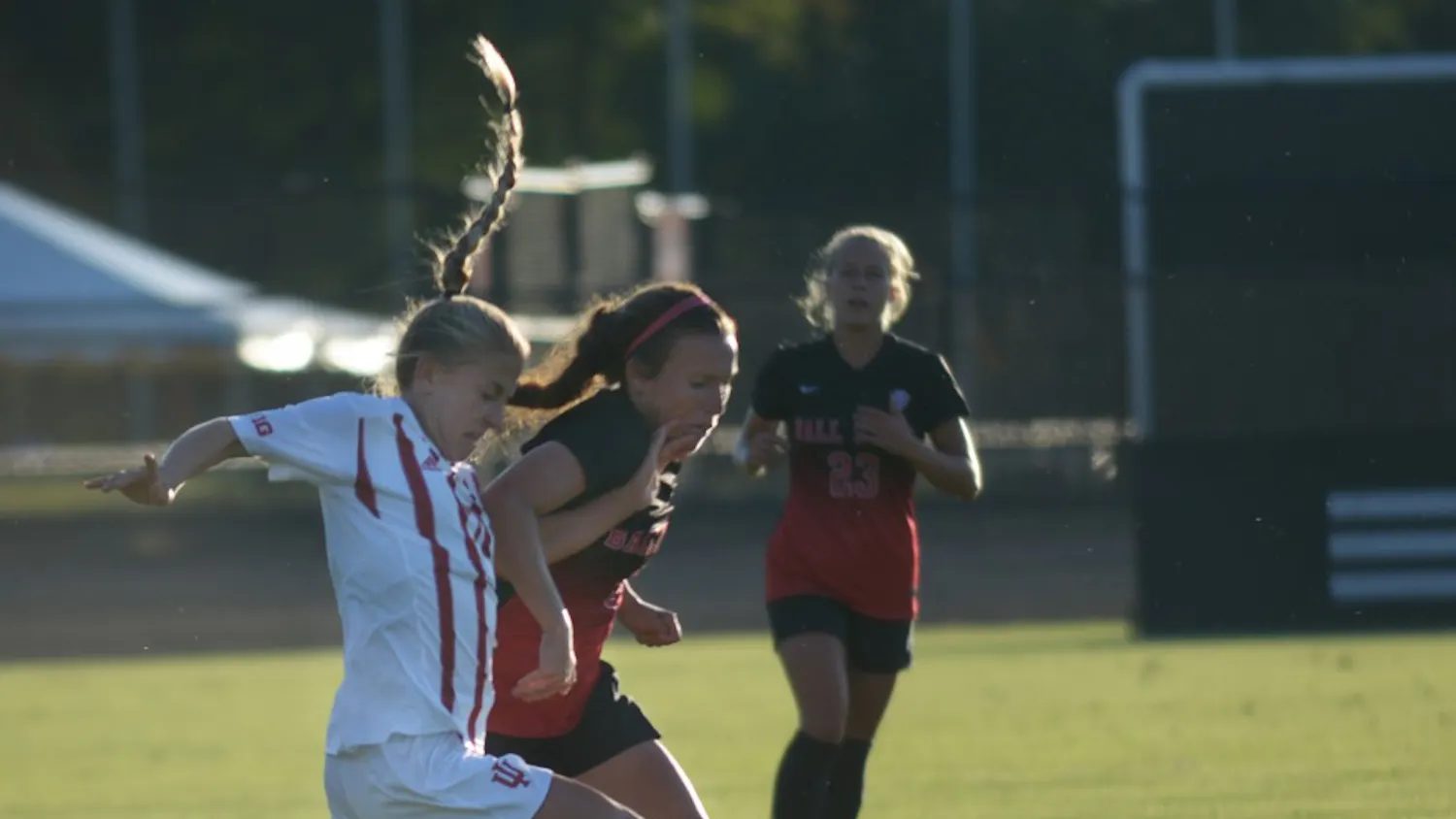 Sophomore Midfielder Kayla Smith holds off a Ball State University Cardinals' defender at Bill Armstrong stadium on Sunday evening. IU tied the game 1-1.