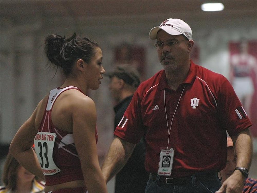 Sophomore Stephanie Chin talks with her coach after a jump Saturday afternoon at the Harry Gladstein Fieldhouse. Chin was one of many track team members to participate in the Big Ten Championships this weekend.