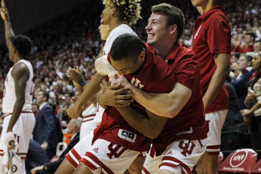 <p>Junior guard Johnny Jager hugs senior guard Quentin Taylor after IU takes the lead against University of Louisville on Dec. 8 at Simon Skjodt Assembly Hall. IU defeated Louisville 68-67.</p>