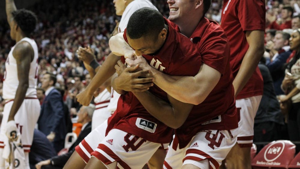 Junior guard Johnny Jager hugs senior guard Quentin Taylor after IU takes the lead against University of Louisville on Dec. 8 at Simon Skjodt Assembly Hall. IU defeated Louisville 68-67.