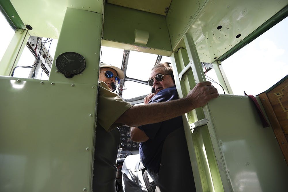 Volunteer pilot Tom Leahy (left) and co-pilot Adrian VanLeeuwen get the plane ready for takeoff. For the 75th anniversary of the Monroe County Airport, they offered the opportunity to purchase a ride on the plane.