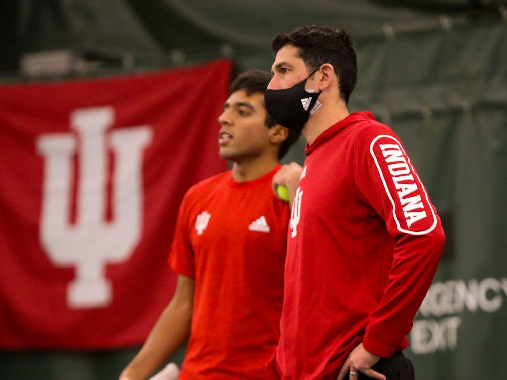 IU head coach Jeremy Wurtzman meets with sophomore singles player Nishanth Basavareddy during Saturday’s home match against Bellarmine University at the IU Tennis Center. Indiana will play University of Louisville on Feb. 26, 2022, in Louisville, Kentucky. 