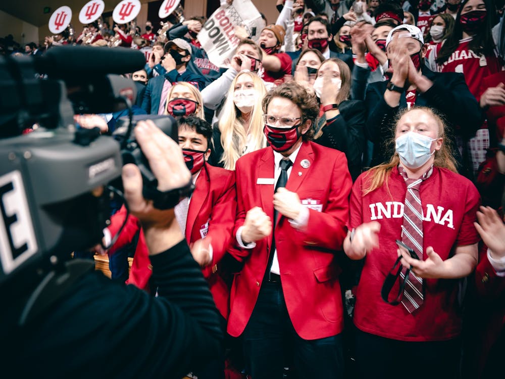 IU seniors Nicholas Stevens and Cassidy Slavik cheer for a television camera before the game. &quot;Because of the pandemic and being away forever, this is an insane environment to be a part of,” Stevens said.