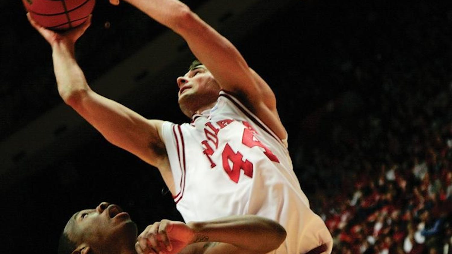 In his final home game as an Indiana Hoosier, senior forward Kyle Taber stretches for a shot under the basket during the first half of the Hoosiers game against Michigan State Tuesday evening at Assembly Hall.