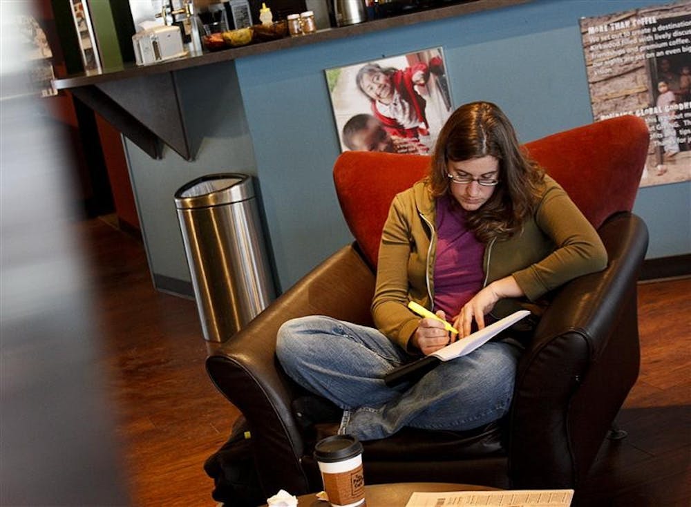 Lauren Schmidt studies Tuesday afternoon at the Pour House Cafe. Many students and Bloomington residents escaped the recent snow storms by drinking hot drinks around town.